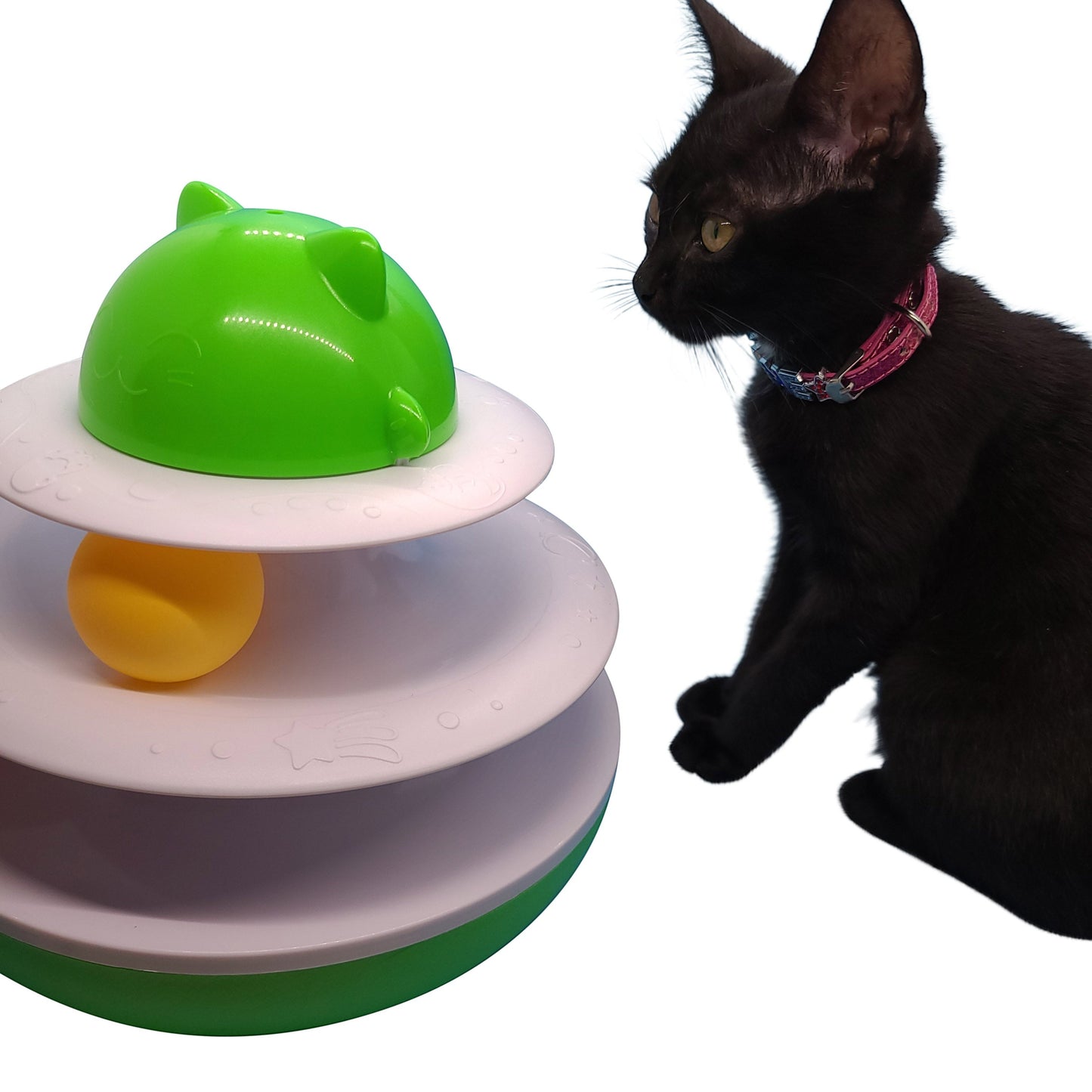 Albert Catstein turntable cat toy with green top, white tiers, and a yellow ball. A black cat watches the toy.